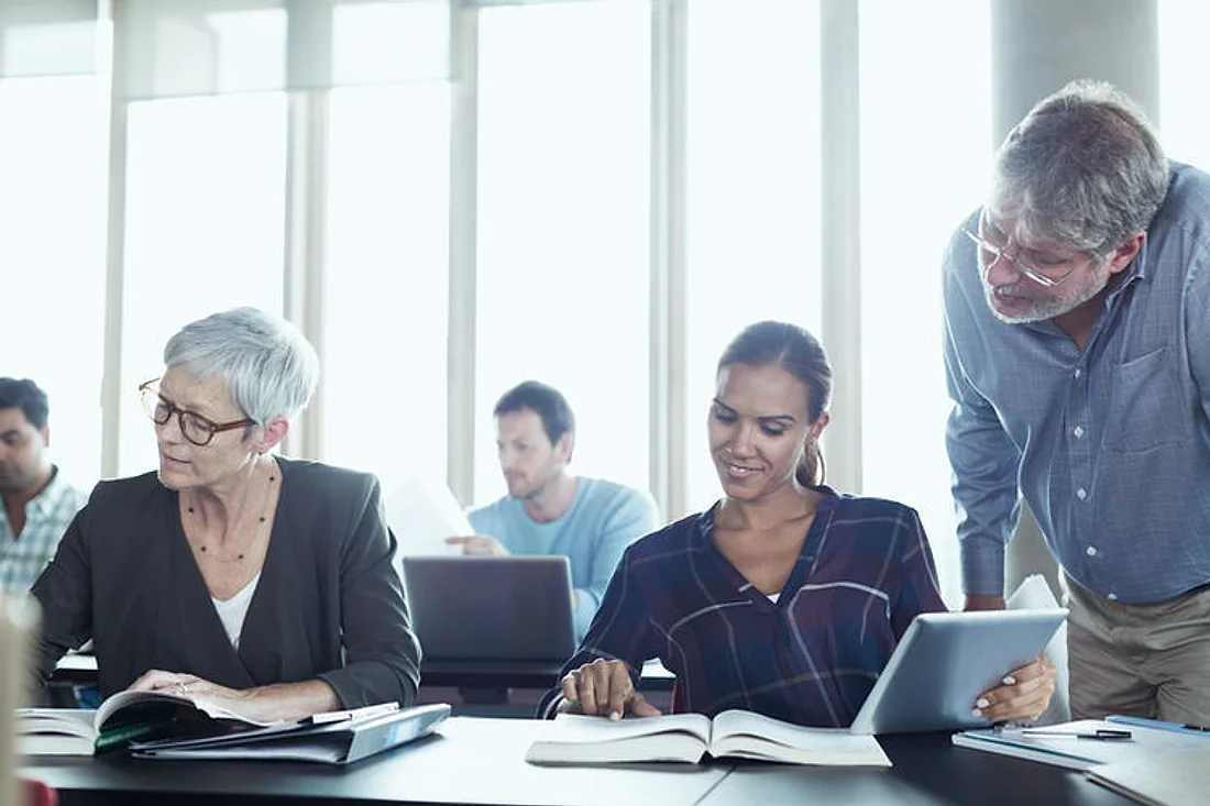 Adults learning together in a training room